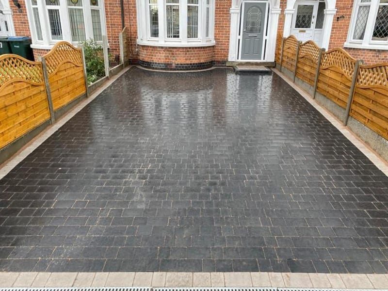 Dark block paving driveway with pale edging