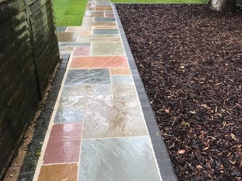 Natural stone garden path with contrasting block edging